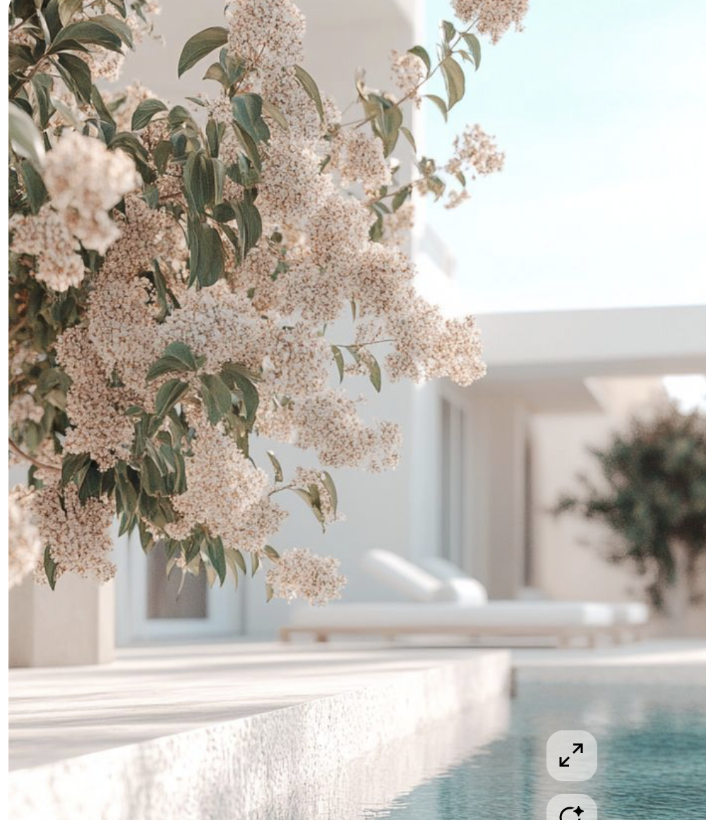 Soft white florals beside a tranquil pool and minimalist villa in golden afternoon light